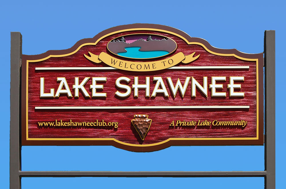 The red and gold Welcome to Lake Shawnee sign against a blue sky